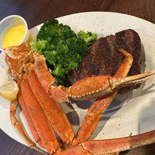 Sommer's Place surf and turf with snow crab legs, steak, broccoli, lemon, and butter.